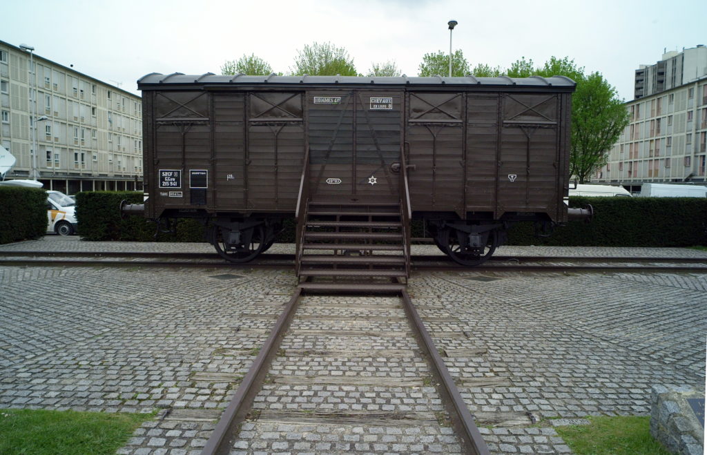 A train is parked on the side of a building