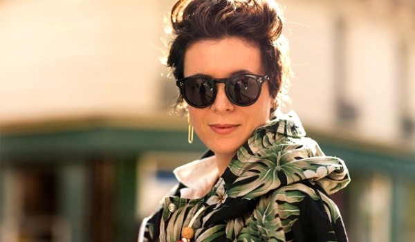 A person wearing sunglasses posing for the camera