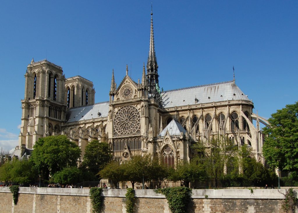 A large stone building with Notre Dame de Paris in the background