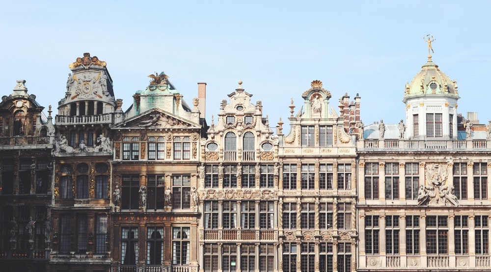 A bunch of furniture in front of a large building with Grand Place in the background