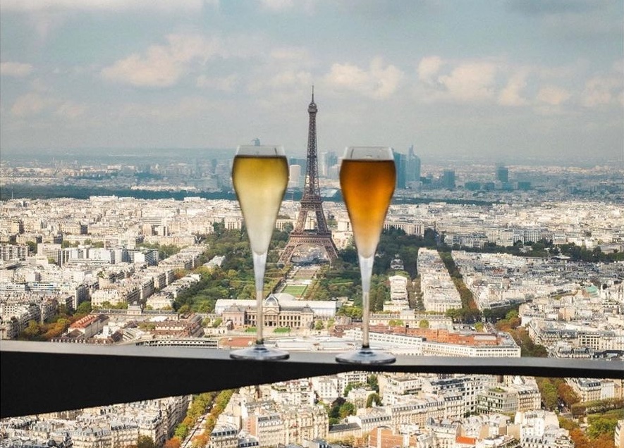 Two glasses of champagne against Eiffel Tower backdrop