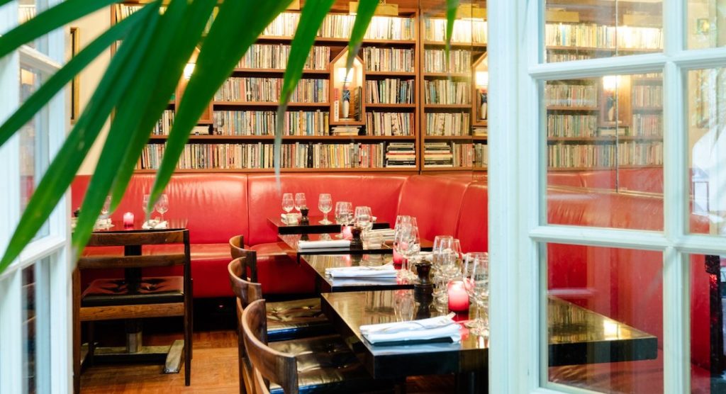 A dining room table and chairs in a library