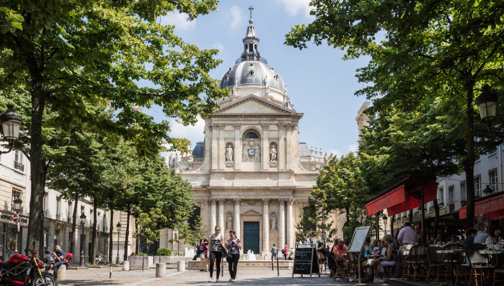 A large clock tower towering over Sorbonne street