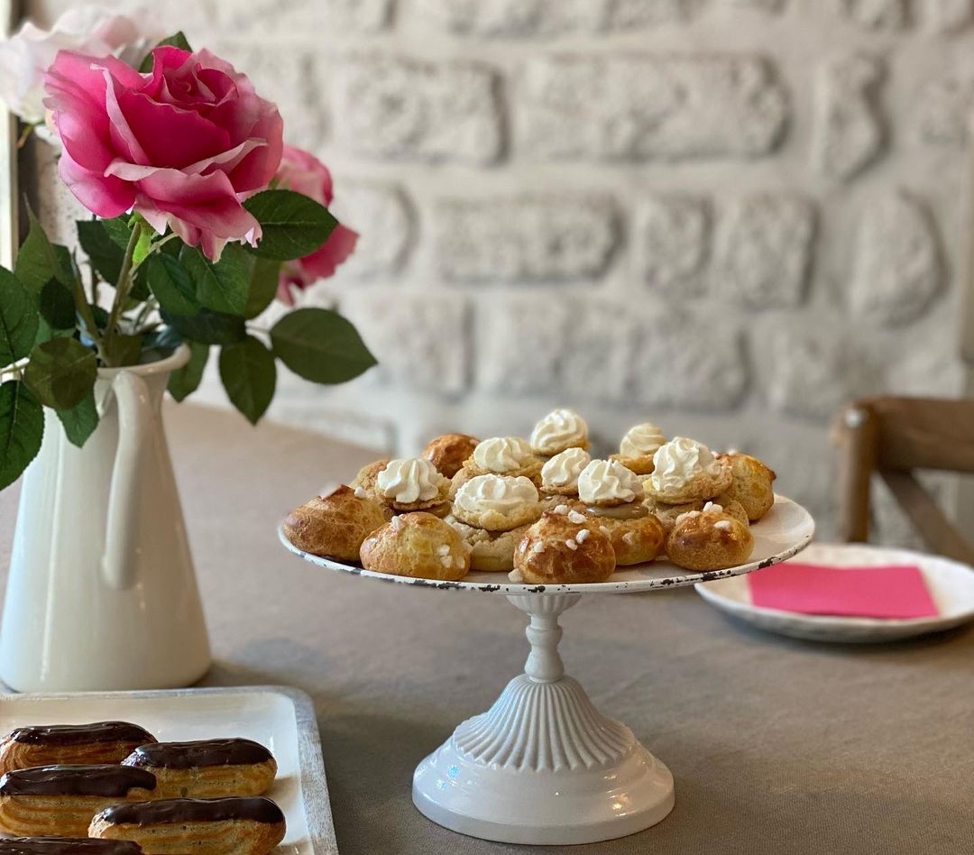 Choux pastries and flowers on a table