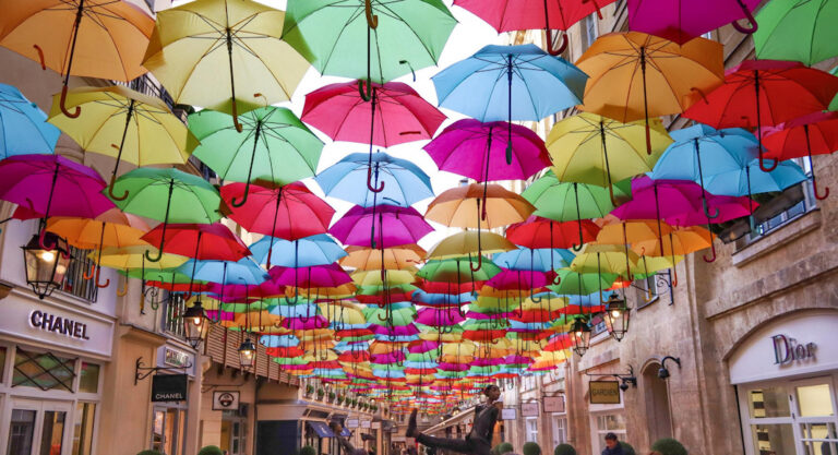 A colorful umbrella hanging from a building