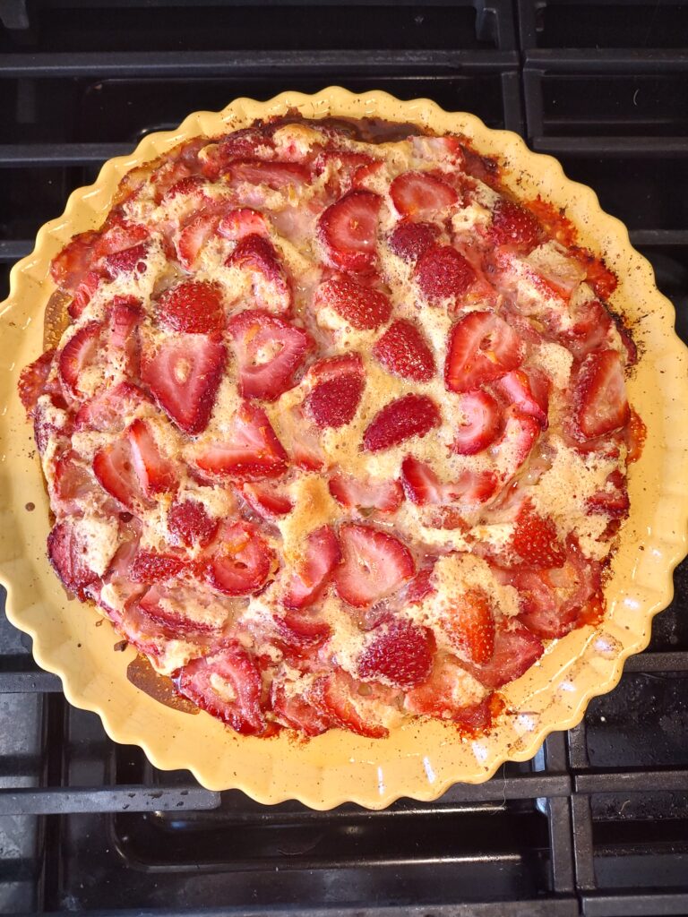 A pizza sitting on top of a pan on a stove