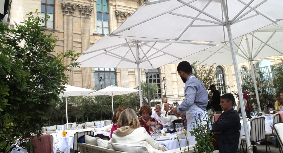 People dining under white umbrellas at LouLou