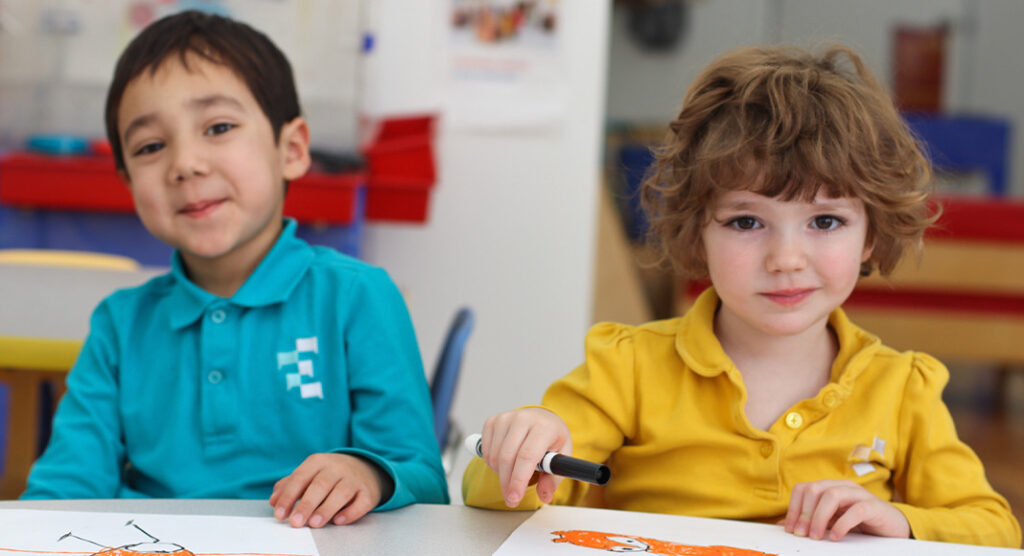 A little boy sitting at a table