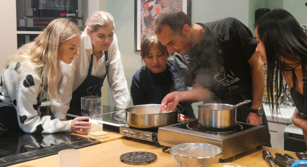 A group of people preparing food in a kitchen