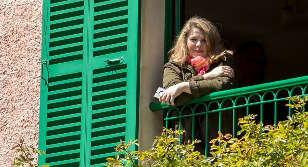Erin Zhurkin reflecting at the window in Giverny, France