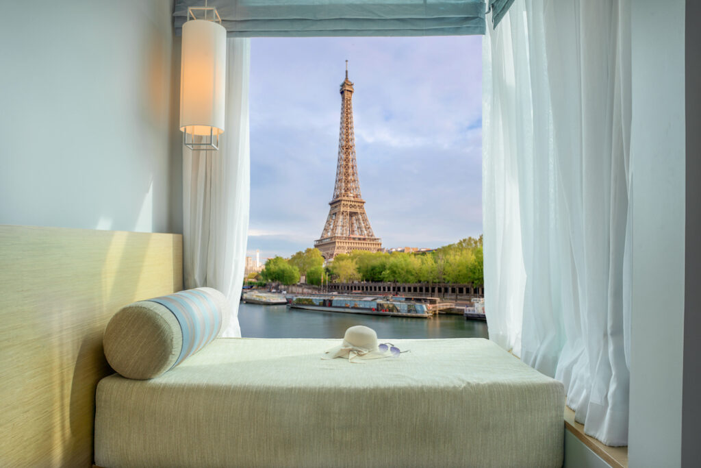 Summer, Travel, Vacation and Holiday in Paris, France. Beautiful Eiffel tower view at window in resort near Seine river, Paris, France.