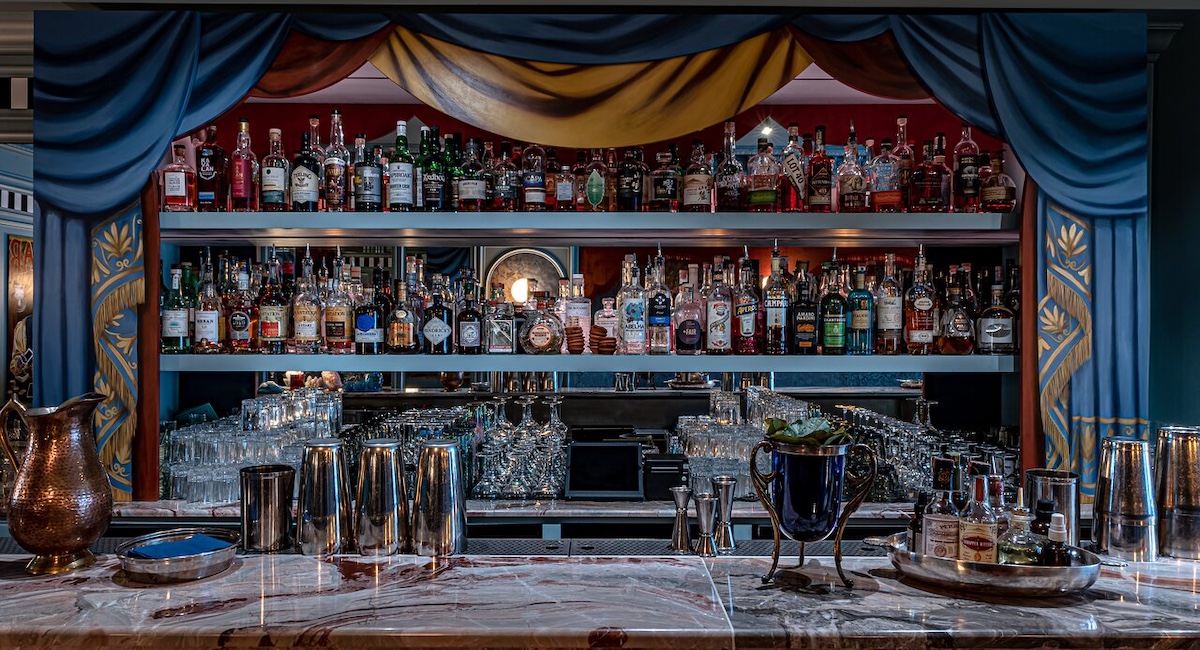 Beautiful back bar with blue curtains framing it