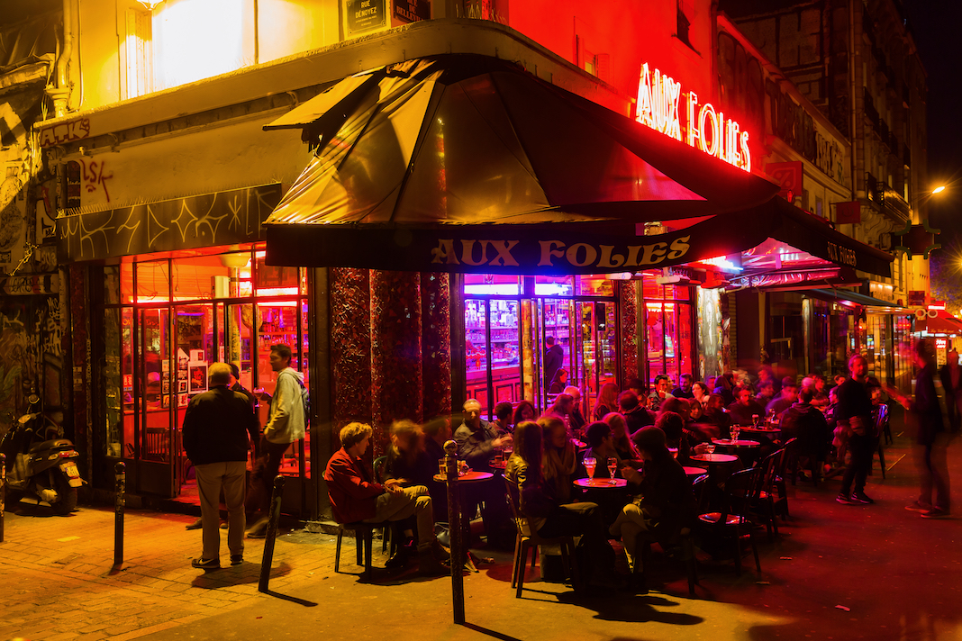 Paris, France - October 17, 2016: cafe bar in Belleville with unidentified people at night. Belleville is a colourful, multi-ethnic neighbourhood and also home to one of the citys two Chinatowns