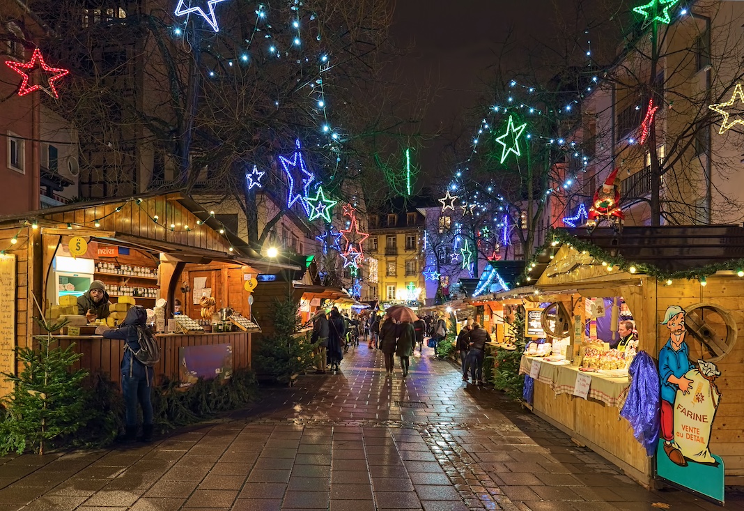 STRASBOURG, FRANCE - DECEMBER 15, 2019: Small Christmas market on Place des Meuniers (Square of millers) in Petite France quarter in dusk. The market features products from small producers from Alsace