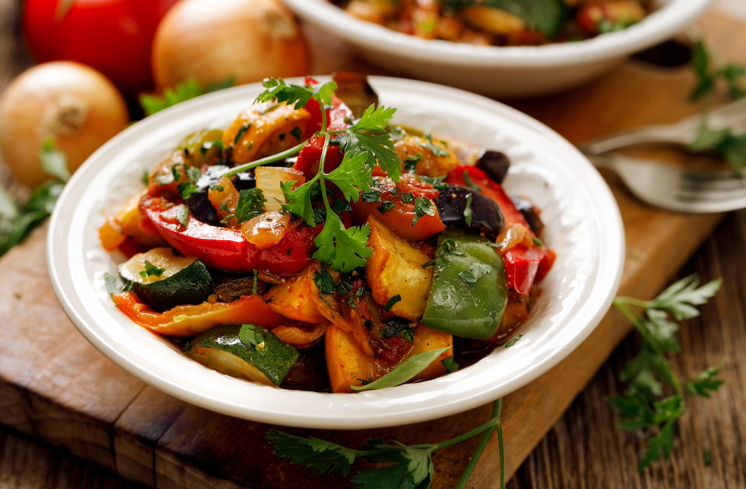 Ratatouille, Vegetarian stew made of zucchini, eggplants, peppers, onions, garlic and tomatoes with aromatic herbs. Traditional french food