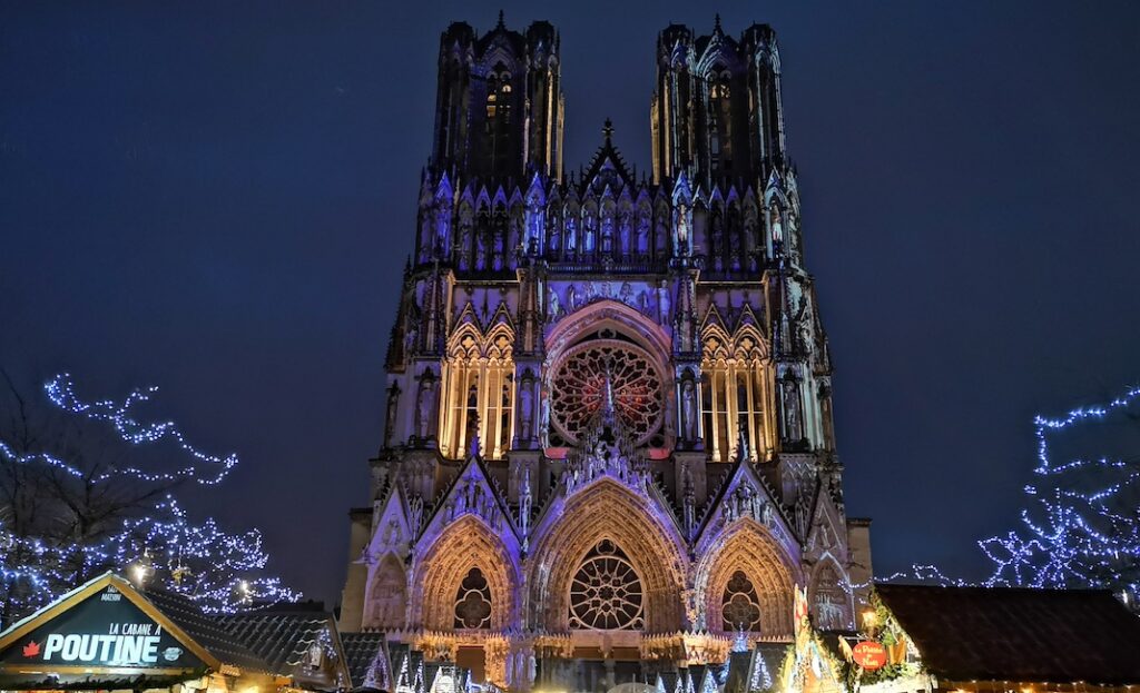 REIMS, FRANCE - DECEMBER 9th, 2018 : Christmas Market by night in Reims with the Cathedral