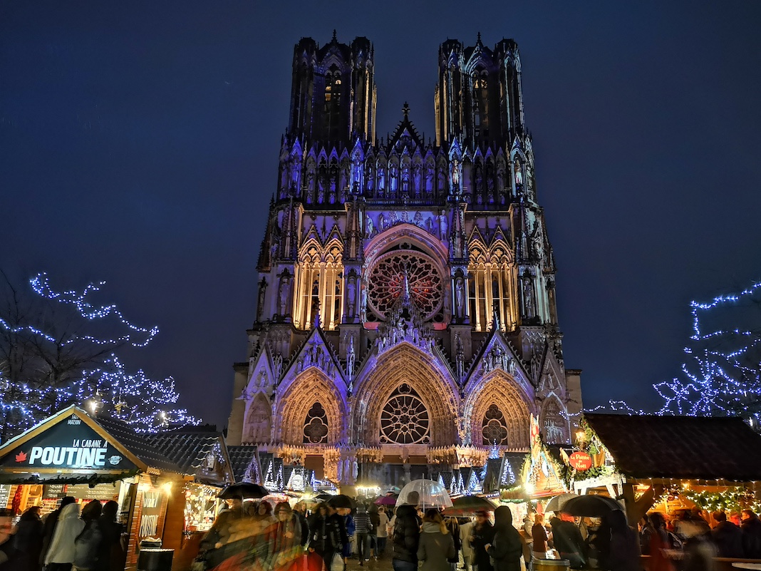 REIMS, FRANCE - DECEMBER 9th, 2018 : Christmas Market by night in Reims with the Cathedral
