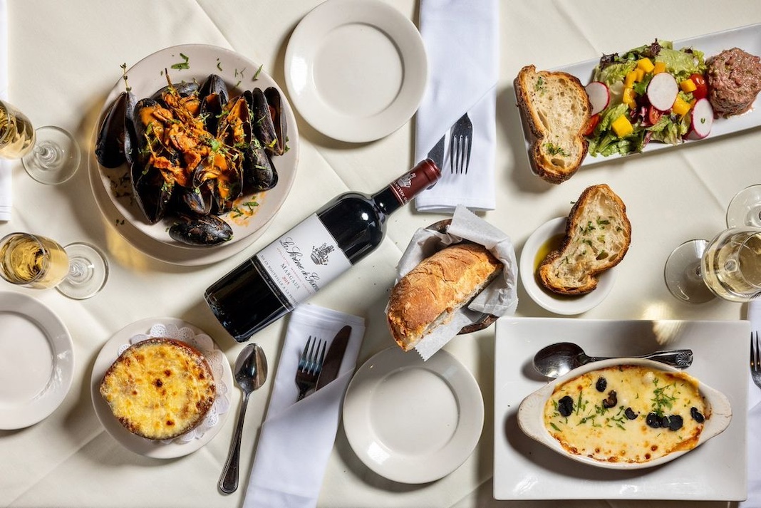 Tablescape with wine, mussels, and other dishes