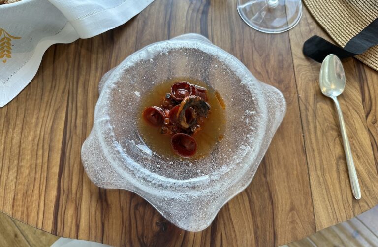 Brothy octopus in clear glass bowl