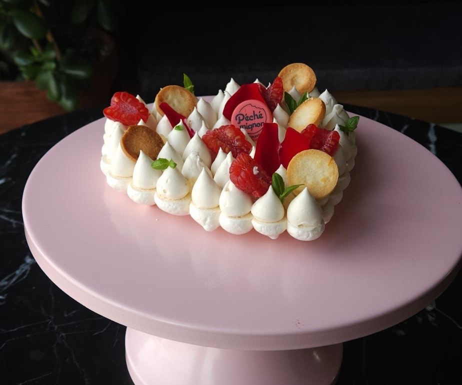 Heart-shaped pavlova on pink cake stand