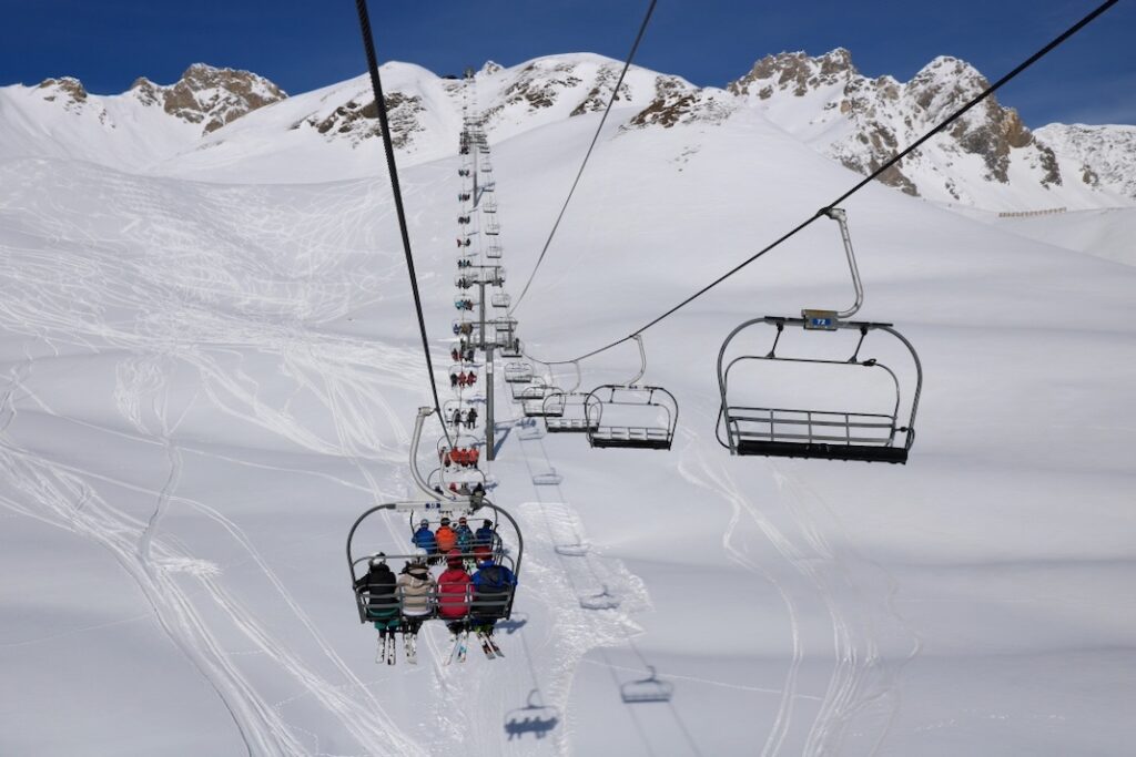 Ski lift against white snow and blue sky
