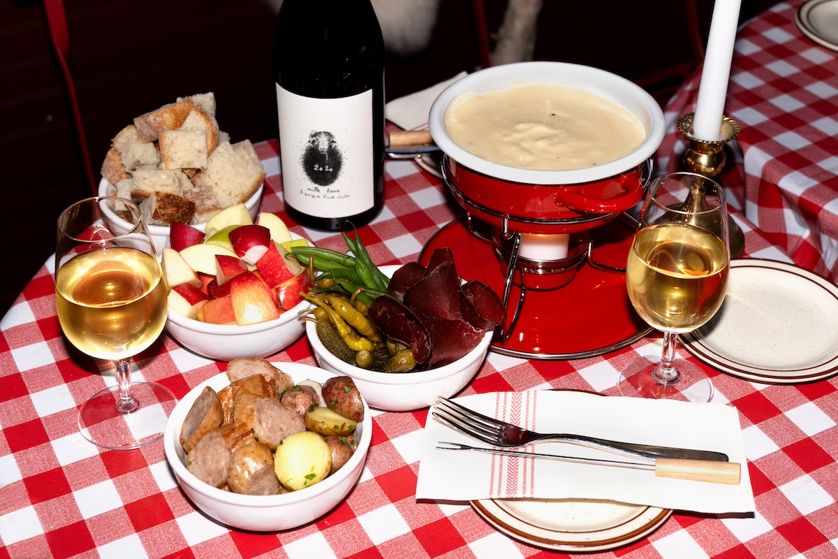 Fondue pot and accoutrements on checkered tablecloth