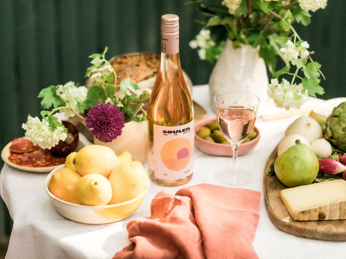 Bottle of rosé on table with lemons and other dishes