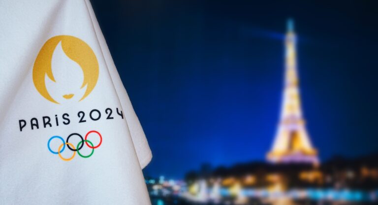Paris 2024 Olympic flag against Eiffel Tower backdrop
