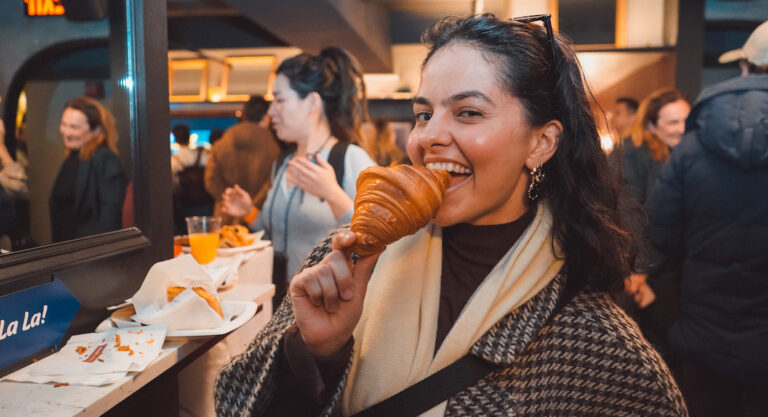 Woman biting into croissant