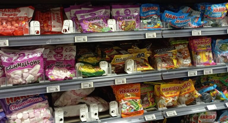 A shelf of candies at a French grocery store