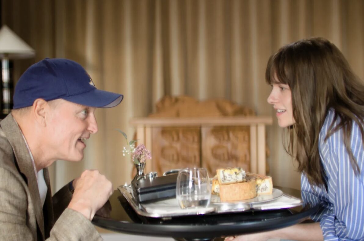 A man and a woman smile at each other across a table