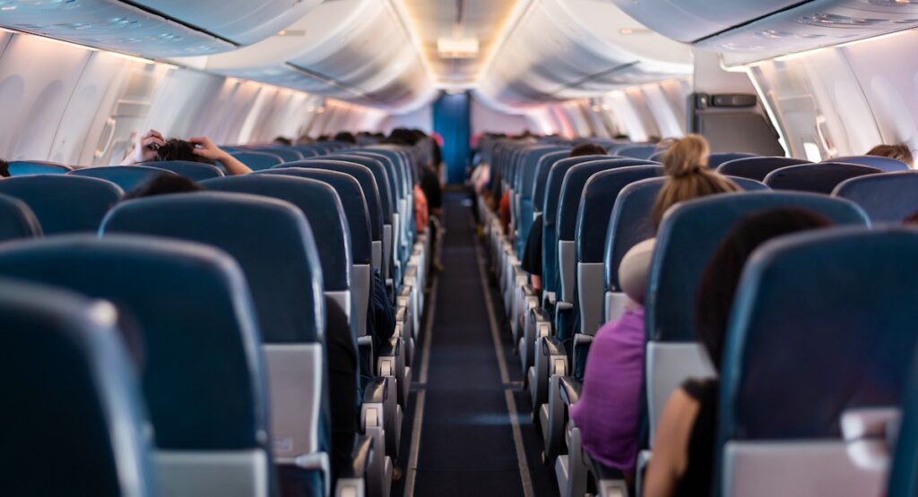 View of airplane seats and passengers