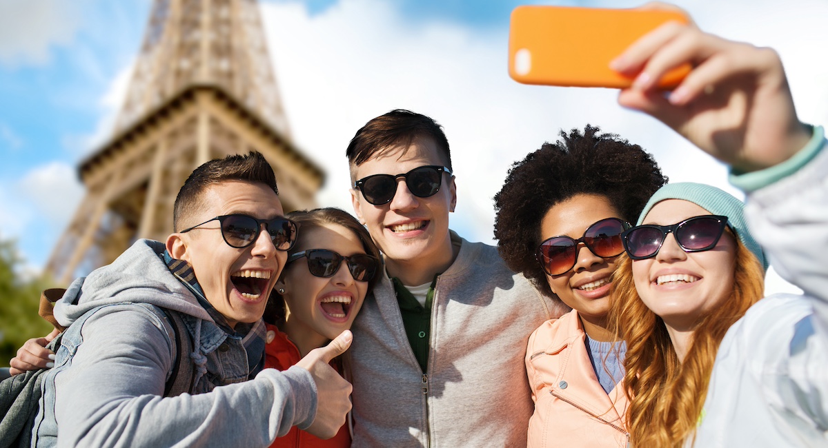 Tourists taking a selfie by the Eiffel Tower