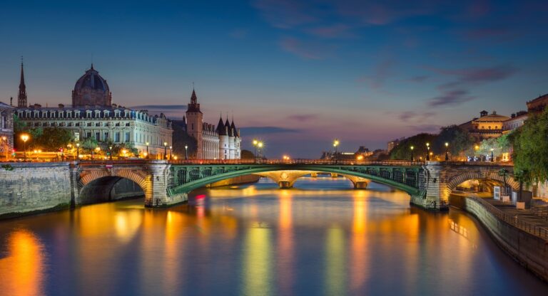Paris Panorama. Panoramic image of Paris riverside during twilight blue hour.