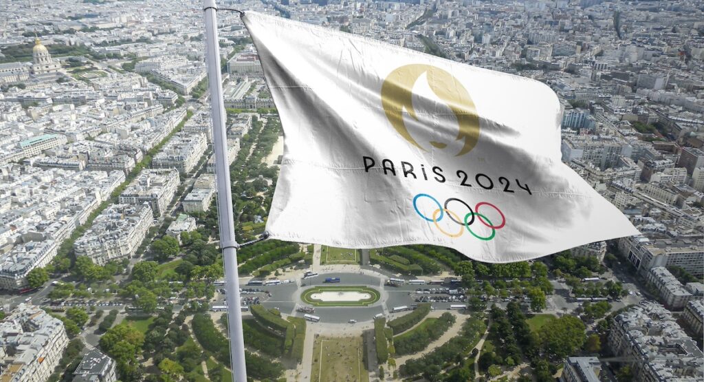 Paris 2024 flag flying over the city.