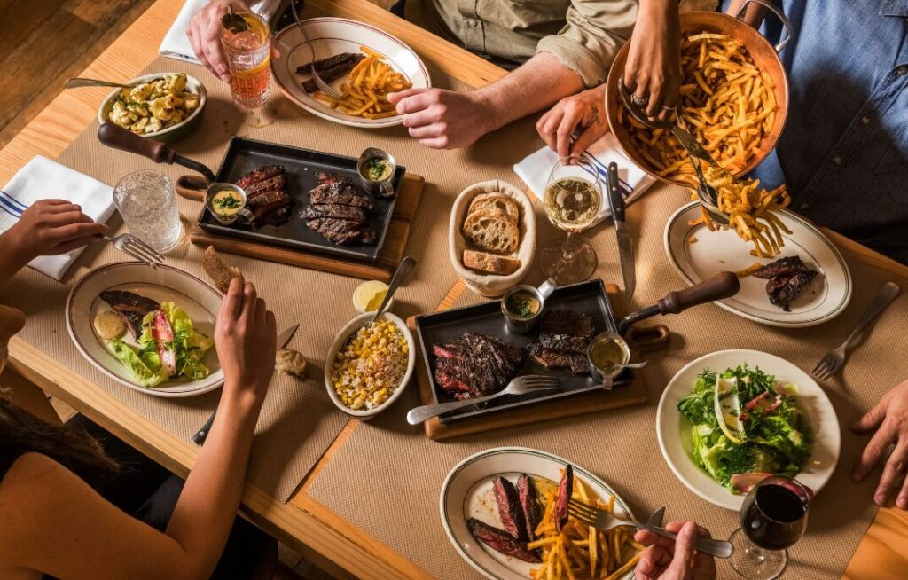 People enjoying steak and fries, aerial view