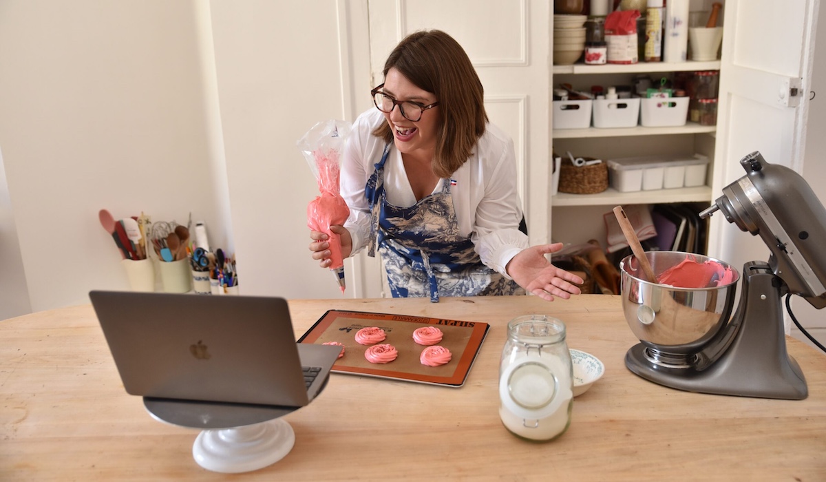 Woman baking to Zoom audience on laptop