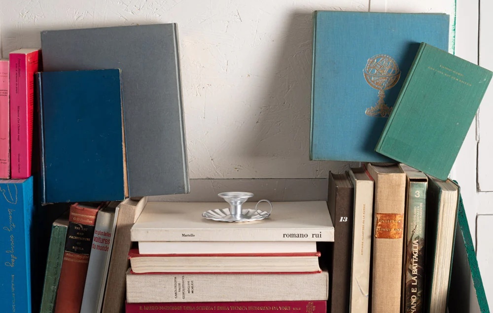 Candle holder on pile of books
