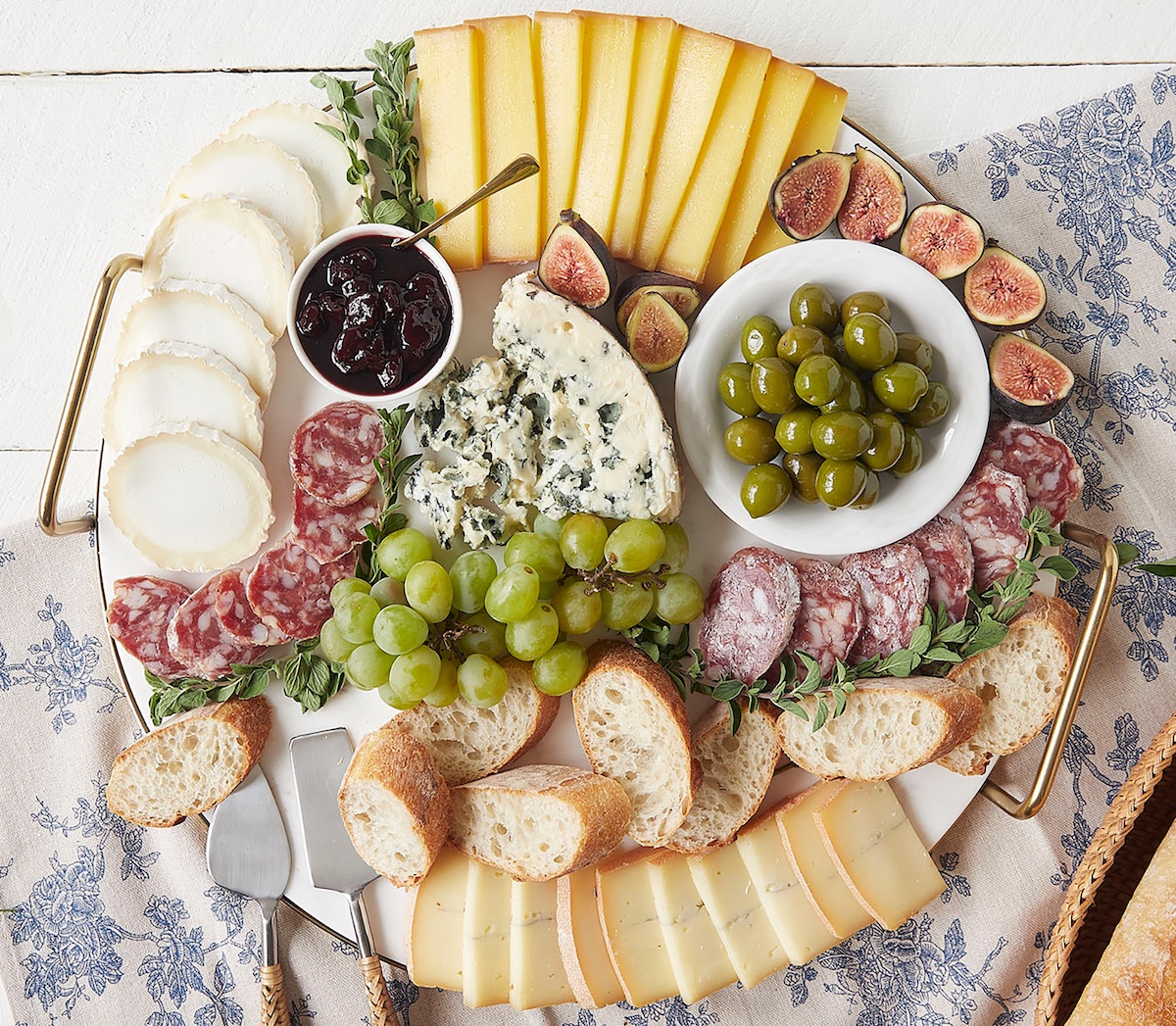 Cheese plate with olives, salami, and other accoutrements