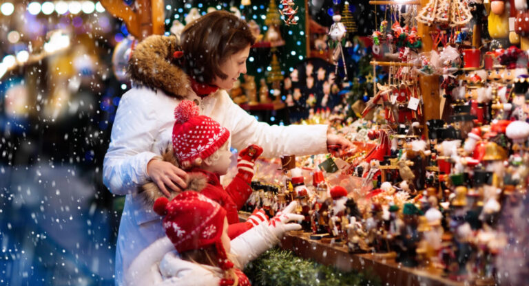 Family shopping presents in Christmas market.