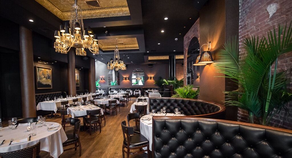 Restaurant interior with black leather booths and chandeliers