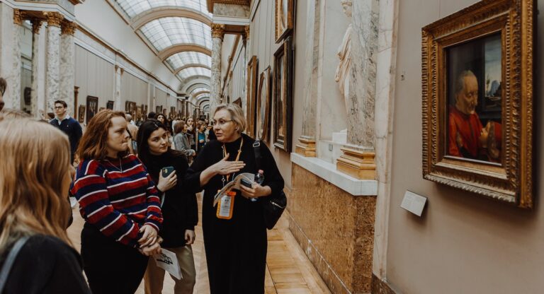 Louvre tour guide with group of people