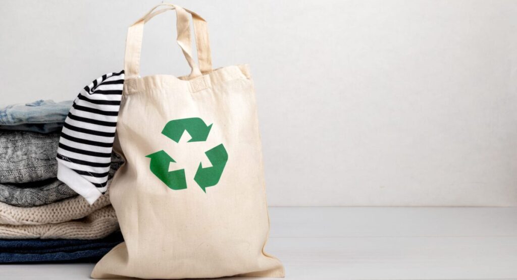 Reusable tote bag with recycling emblem on it.