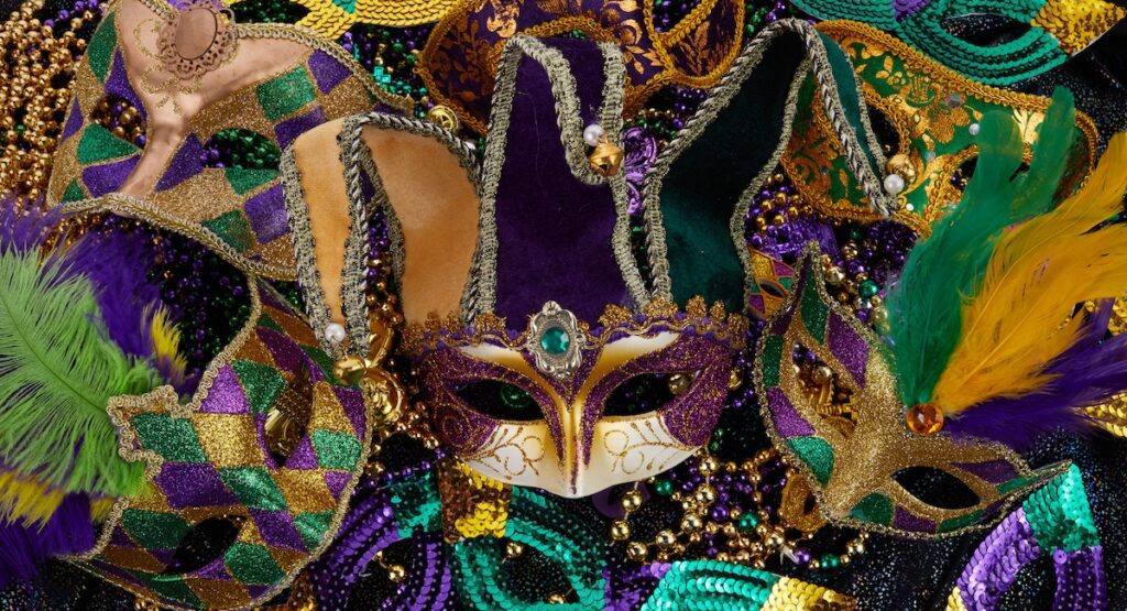 Mardi Gras Mask and colorful Mardi Gras Beads Background.