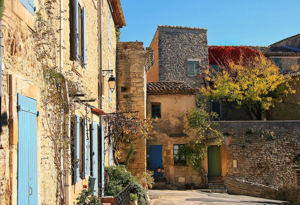 Village courtyard with blue shuttered-houses in Goult