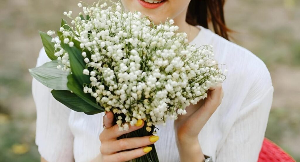 Woman holding lily of the valley bouquet