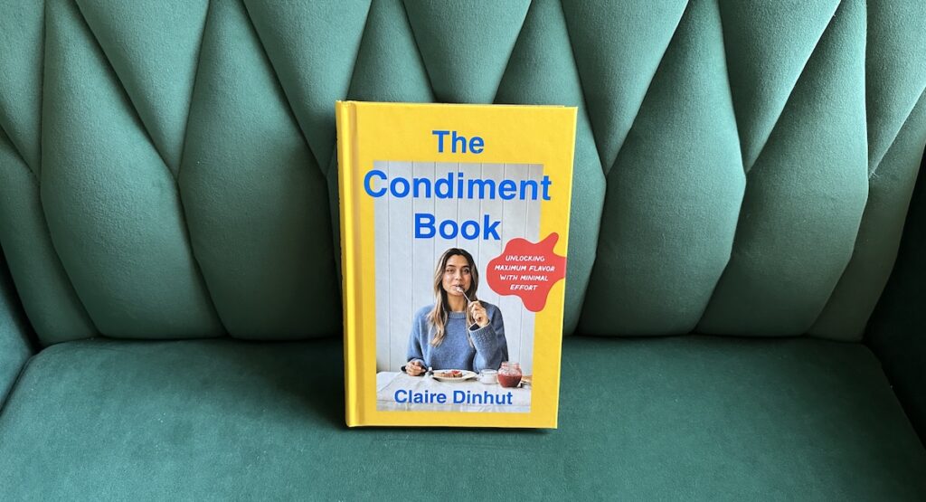 The Condiment Book by Claire Dinhut on green velvet background