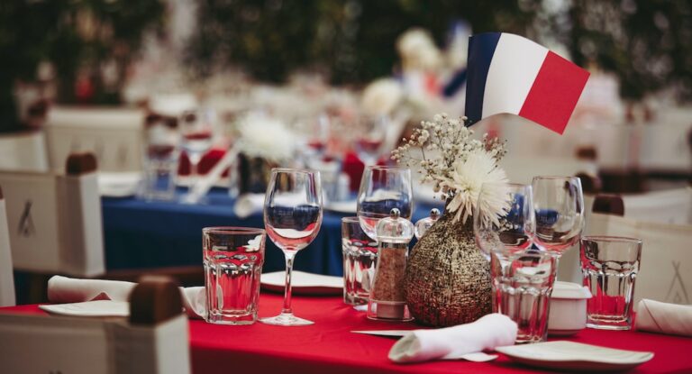 Table set with wine glasses and small French flag