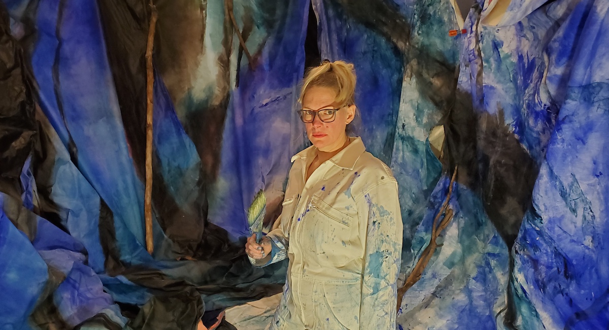 Woman posing in front of art installation