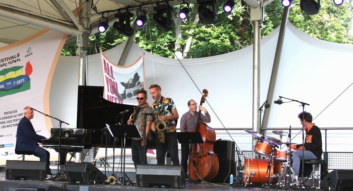 Musicians performing on outdoor stage at Parc Floral